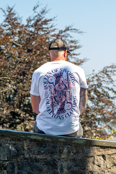 Back view of a man wearing the white Queen of Swords graphic T-shirt by Old Elton’s Clothing.